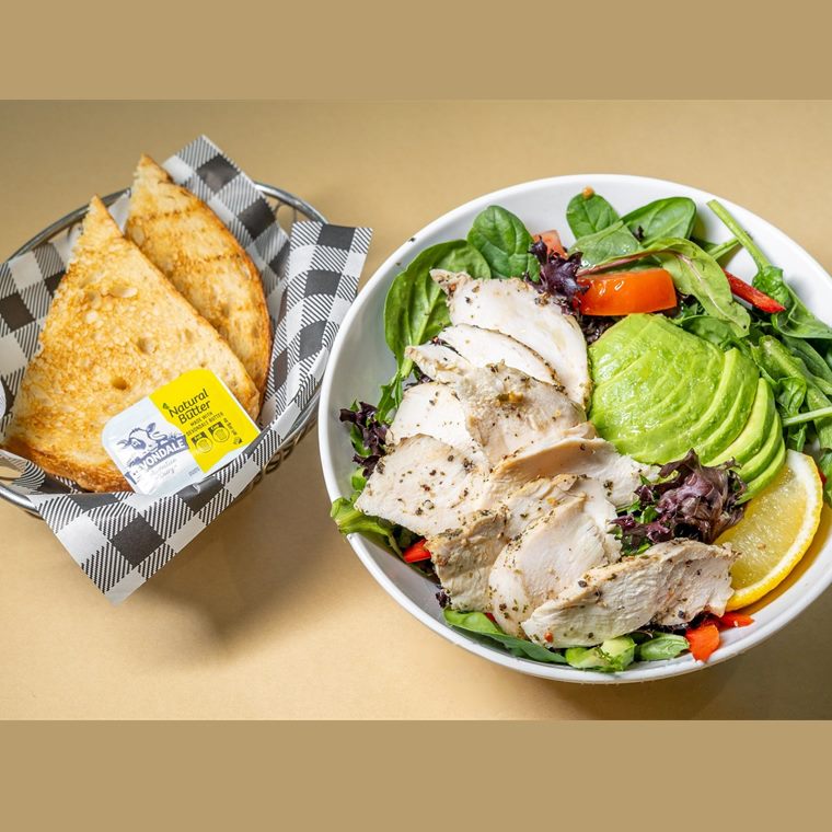 Sliced grilled chicken over avocado, tomato, cucumber and mixed leaves, with toasted pita.
