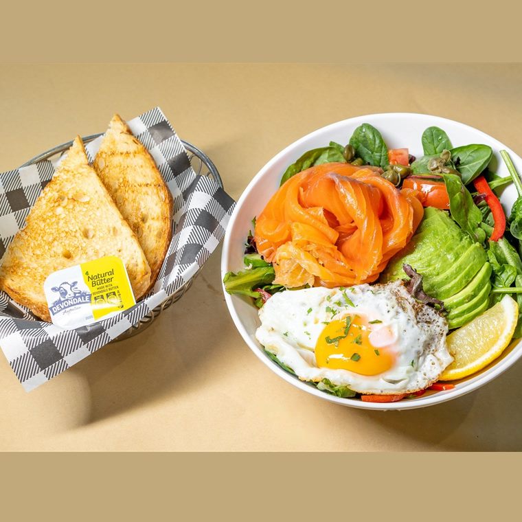 Smoked salmon with a fried egg, avocado, cucumber, capers and mixed leaves.