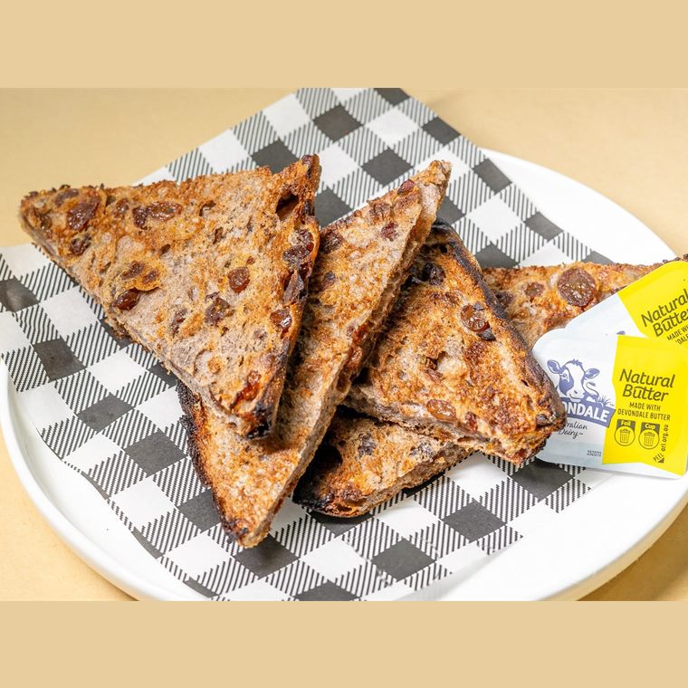 Thick slices of cinnamon and raisin bread, toasted and cut into triangles, served with butter.